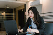 © Near - asian business woman using laptop computer in office