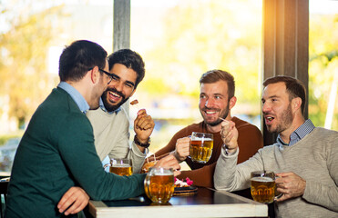 Wall Mural - Friends talking and drinking beer in pub