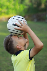 Aufkleber - handsome boy soccer player in a yellow t-shirt on a soccer field with a ball