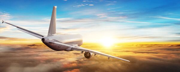 Commercial airplane flying above clouds