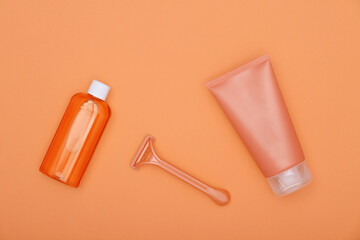 Wall Mural - Feminine shaving set on orange paper