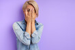 © Roman - portrait of caucasian scared woman closing her face because of fear, isolated purple background. emotions, people concept