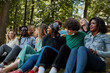 © Roman - happy caucasian and african american people have rest in the public park. people urge to be tolerant of each other. friendship, people relationships