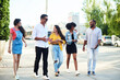 © etonastenka - Lovely friends of different nationalities walk around the city and talk on different topics