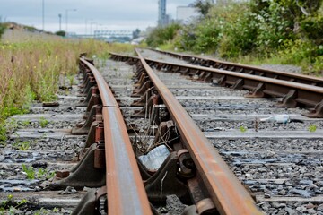 Train tracks and rusty rails. Rarely used old train tracks leading to old deserted docklands in Barry. They are just used for shunting trucks ready for loading