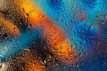 Colorful background with raindrops, blurred style. Bright tints of blue and orange colors, trendy pattern, wallpaper or banner design