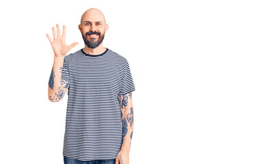 Young handsome man wearing casual clothes showing and pointing up with fingers number five while smiling confident and happy.