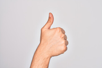 Hand of caucasian young man showing fingers over isolated white background doing successful approval gesture with thumbs up, validation and positive symbol