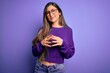 © Krakenimages.com - Young beautiful smart woman wearing glasses over purple isolated background Hands together and fingers crossed smiling relaxed and cheerful. Success and optimistic