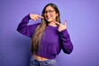 © Krakenimages.com - Young beautiful smart woman wearing glasses over purple isolated background smiling cheerful showing and pointing with fingers teeth and mouth. Dental health concept.