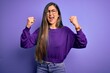 © Krakenimages.com - Young beautiful smart woman wearing glasses over purple isolated background angry and mad raising fists frustrated and furious while shouting with anger. Rage and aggressive concept.