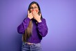 © Krakenimages.com - Young beautiful smart woman wearing glasses over purple isolated background shocked covering mouth with hands for mistake. Secret concept.
