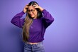 © Krakenimages.com - Young beautiful smart woman wearing glasses over purple isolated background suffering from headache desperate and stressed because pain and migraine. Hands on head.
