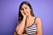 © Krakenimages.com - Young beautiful woman wearing casual summer striped top over purple isolated background thinking looking tired and bored with depression problems with crossed arms.
