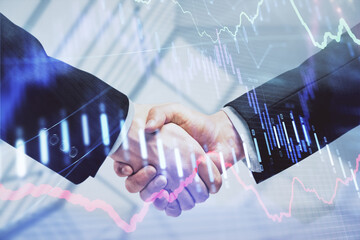 Double exposure of forex graph hologram and handshake of two men. Stock market concept.