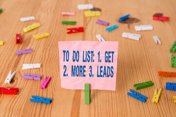 Fototapete - Conceptual hand writing showing To Do List: 1. Get 2. More 3. Leads. Concept meaning advertising plan to attract clients Colored crumpled papers wooden floor background clothespin