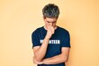 © Krakenimages.com - Young handsome man wearing volunteer t shirt feeling unwell and coughing as symptom for cold or bronchitis. health care concept.
