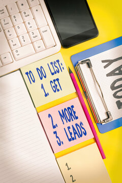 Writing note showing To Do List: 1. Get 2. More 3. Leads. Business concept for advertising plan to attract clients Empty papers with copy space on yellow background table