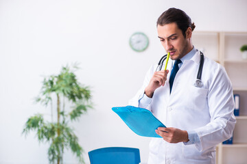 Young male handsome doctor working in the clinic