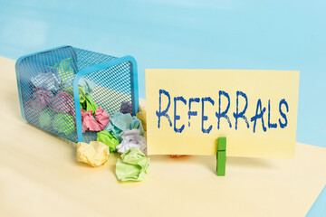 Poster - Handwriting text writing Referrals. Conceptual photo someone or something to research study or take any further action Trash bin crumpled paper clothespin empty reminder office supplies tipped
