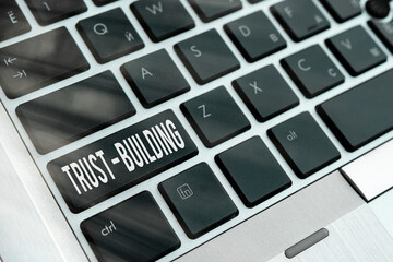 Wall Mural - Word writing text Trust building. Business photo showcasing developing trust in so they can function effectively Pc keyboard key with empty note paper above background copy space