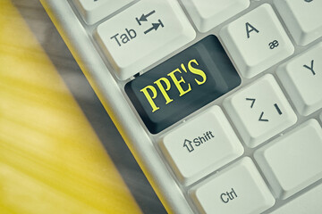 Poster - Conceptual hand writing showing Ppe s is. Concept meaning Specialized equipment for protection against health and safety hazard Colored keyboard key with accessories arranged on copy space