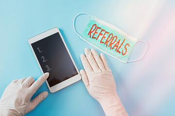 Poster - Writing note showing Referrals. Business concept for someone or something to research study or take any further action Contaminated electronic gadgets controlled by disinfectant