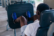 © twinsterphoto - Back view of African American man doing exercise on leg press during fitness training in modern gym.