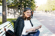 © shurkin_son - Modern energetic elderly woman freelancer working remotely using electronic portable computer on bench, smiling broadly at camera, enjoying high speed wireless internet connection in city park