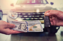 Purchase Deal Of Buy Or Rent New Car. Hand With Dollar Money And Car Keys