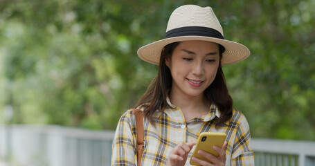 Wall Mural - Woman use of mobile phone for location while go hiking