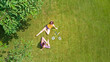 © Iuliia Sokolovska - Family fitness and sport outdoors, active mother and daughter teenager playing badminton in park, aerial top view from above