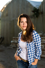 Portrait of lovely farmer woman in the backyard of village house