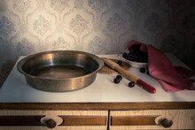 Old Copper Bowl For Cooking Jam, Wooden Spoon And Cherry In A Plate On A Vintage Buffet. Retro Still Life.