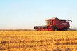 © Georgy - Combine harvester at work harvesting field of crop. Harvest season themes and other agriculture