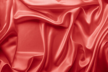 Beautiful elegant wavy hot red satin silk luxury cloth fabric texture, abstract background design. Wallpaper, banner or card with copy space.