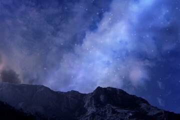 Wall Mural - photo of the night sky with the milky way and stars. the dark silhouette of the mountains. tourism.