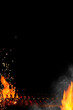 Empty barbecue BBQ grill with flaming fire and sparks, smoldering charcoal, smoke on black background. Close up, copy space