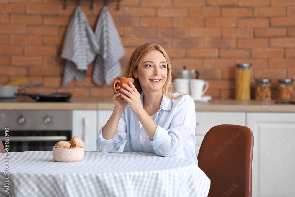 Beautiful woman drinking tea at home