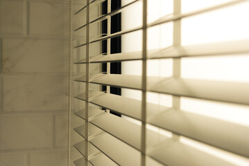 Wall Mural - Close-up open venetian blinds. lighting range control sunlight coming from a window. decoration interior. Modern jalousie.