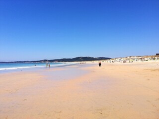 Sticker - Beautiful view of a sandy beach on a sunny summer day with a blue clear sky