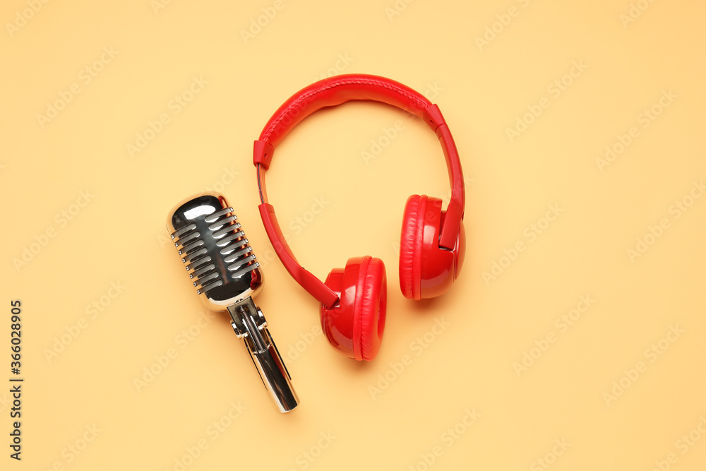 Headphones with microphone on color background