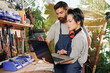 © DragonImages - Team of serious young carpenters checking e-mails from customer on laptop
