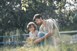 © zinkevych - Dark-haired boy and his father looking at the plant through magnifying glass and looking involved