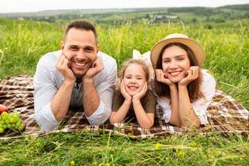 cute family spending time together in the meadow