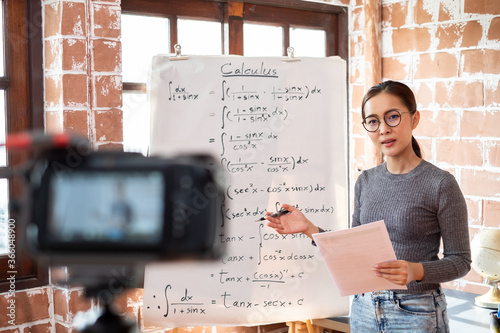Fotomural Asian woman teacher teaching lesson online learning via internet at home, self s