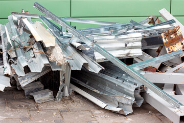 Many rusty metallic steel profile rolls as a garbage at the construction site.