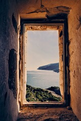 Sticker - Vertical shot of a view to the sea from an abandoned building