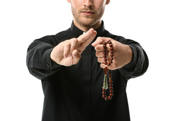 Handsome priest with rosary beads on white background