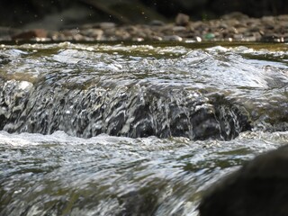 Canvas Print - Splashing water of a waterfall during daytime